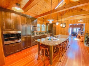 Amazing kitchen with natural lighting that brings out the amazing wood work!