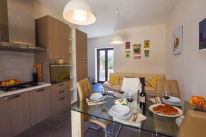 Living room with kitchen, dining table and seating area