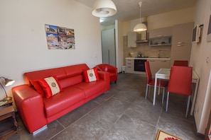 Living room with kitchen, dining table and seating area
