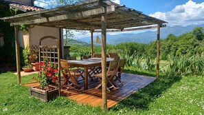 Outdoor shaded dining area seats 8 people
