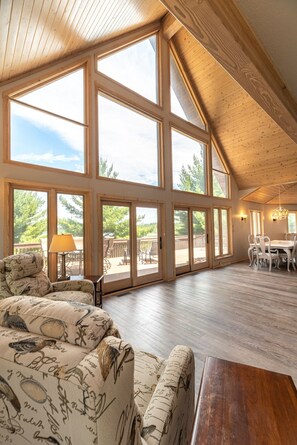 Eastern great room with views of statuesque pines.