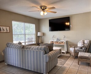 Enjoy your favorite shows on the big screen television in the living room.