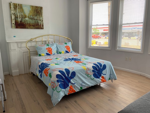 Main bedroom has queen size mattress and a decorative fireplace.