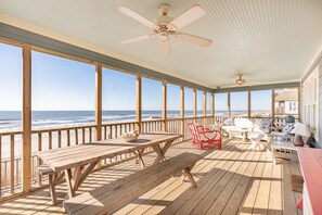 Screened Porch overlooking the atlantic ocean. Outdoor seating and dining area.