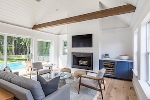 Living Room with wood beams, Gas Fireplace, wine fridge, shiplap, Frame TV 