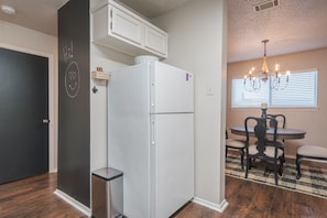 Kitchen has a full size refrigerator.