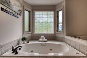 Large soaking tub with natural light in Master bath