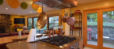 custom copper range hood and stone counters, looking to back patio