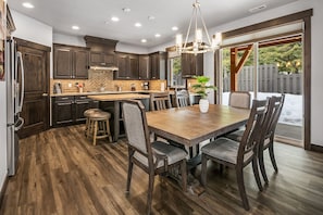 Grizzly Den: - Open concept great room with a large dining table. The dining table can expand to seat 10 comfortably.