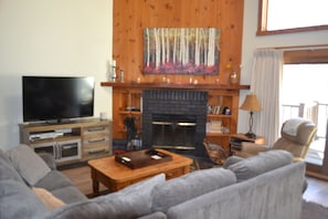 Living room with new pull out sofa, recliner, fireplace, etc.