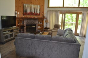 Living room looking outside.. Privacy in summer and a mountain view in winter.