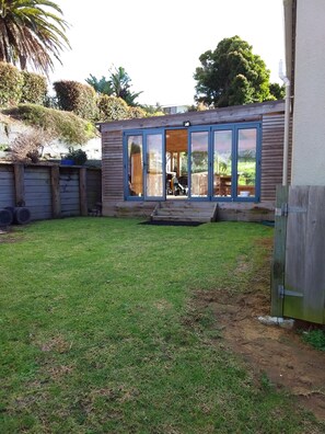 back lawn area leading into outside covered deck