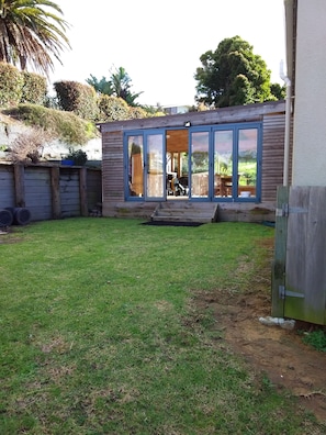 back lawn area leading into outside covered deck