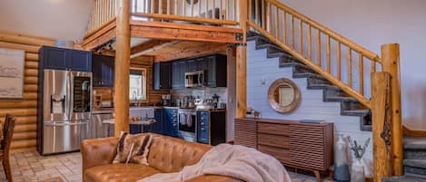 View of kitchen and stairs up to loft and master bedroom