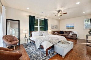 Our master bedroom features a King-size bed, direct access to the deck, a 55-inch Smart TV and an en suite bath.