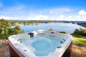 Unwind in our hot tub while surrounded by incredible views of Beaver Lake and the Ozarks.