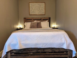 Queen bed in main bedroom.