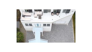 Upper deck with loungers, couch, chairs & tables.