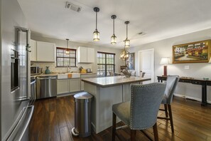 Updated kitchen with stainless steel appliances and farm sink