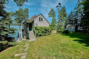 Back side view of the house and the sleeping cabin is to the right.