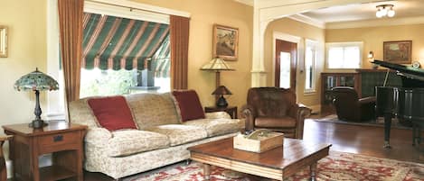 Living Room with Baby Grand Piano and Large Screen Smart TV