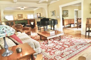 Living Room with Baby Grand Piano and Large screen Smart TV