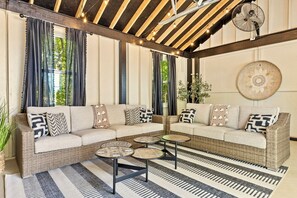 Cozy pool cabana with couches and flat screen Tv