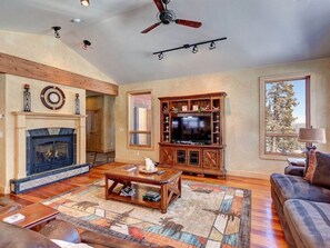 Living room with gas fireplace and large screen TV