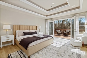 The first of our maximum luxury master suites at this home features a plush King-size bed, seating, a private balcony, and an en suite master bathroom that features a jacuzzi tub.