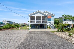 Relax on the screened in porch after a fun day at the beach.