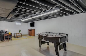 Foosball fun in a large, clean basement.