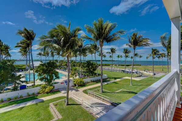 Primary balcony with pool and bay views