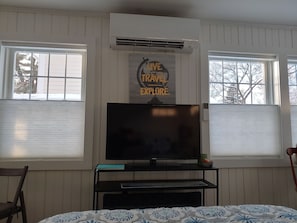 Smart T.V. across from Queen bed. Top down, bottom up shades for privacy & light