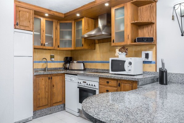 Craft your favorite meals in our fully equipped kitchen with warm wooden accents.