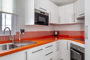 Bold and vibrant kitchen with red accents, fully equipped for culinary enthusiasts.
