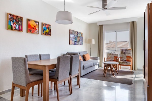 Bright and airy dining area with contemporary art, perfect for enjoying meals in a stylish setting.