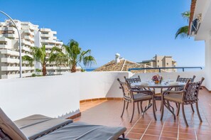 Expansive terrace with ample seating, boasting panoramic views for unforgettable gatherings.