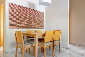 A simple dining area with clean lines and a splash of color, perfect for casual meals and chats.
