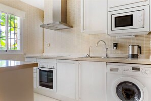 A compact and efficient laundry area, neatly integrated into the kitchen space for ultimate convenience.