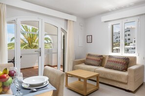 Cozy living room with sofa bed and dining area, perfect for relaxation and meals.