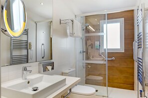 Contemporary bathroom with a spacious shower and sleek design.