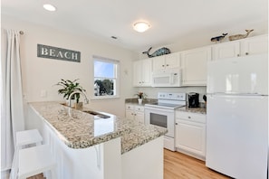 Kitchen is bright, clean, open, & stocked with everything you need