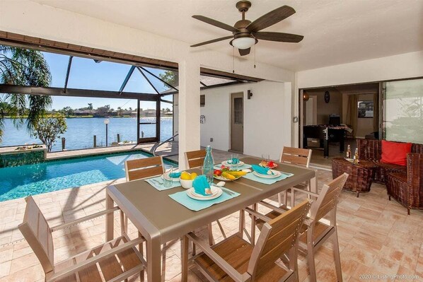 Large Covered Lanai with Southern Pool Exposure and  Sitting Area