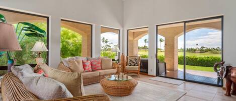 Tropical living room with 70" Smart TV, garden view and lanai access