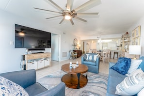 Our warn living room seats 6 in front of the TV. It's perfect for families looking to unwind at the end of a great day on the beach.