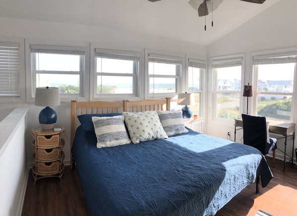 Fourth level bedroom with king bed, desk, smart TV and amazing ocean views