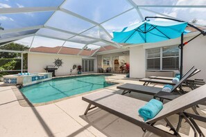 Fully screened lanai with large heated pool and spa. Float in the sunshine on a very large unicorn, or lounge under the umbrella for an afternoon nap!