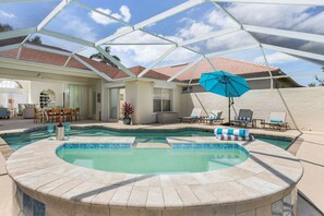 Fully screened lanai with heated, salt water  pool and spa, with loungers, sun shade, an array of floats to choose from and a grill for those that fancy themselves outdoor chefs! Outdoor dining and casual seating too.