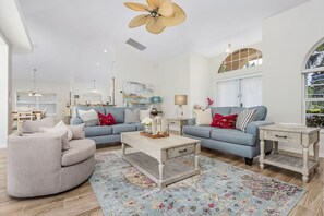 Large open concept living area with plenty of comfy seating for all. The huge sliding doors open completely to provide the indoor/outdoor living we love in Florida.