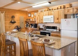 Fully stocked kitchen including crock pot and blender.